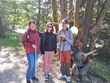 Na fotografii zachyceni zleva: p. Parkosová, DiS., p. Neckářová, p. Spáčil, již tradičně, na cyklostezce do Luk nad Jihlavou ke Kolničce. Za nimi jsou stromy a dřevěný „Alfons“